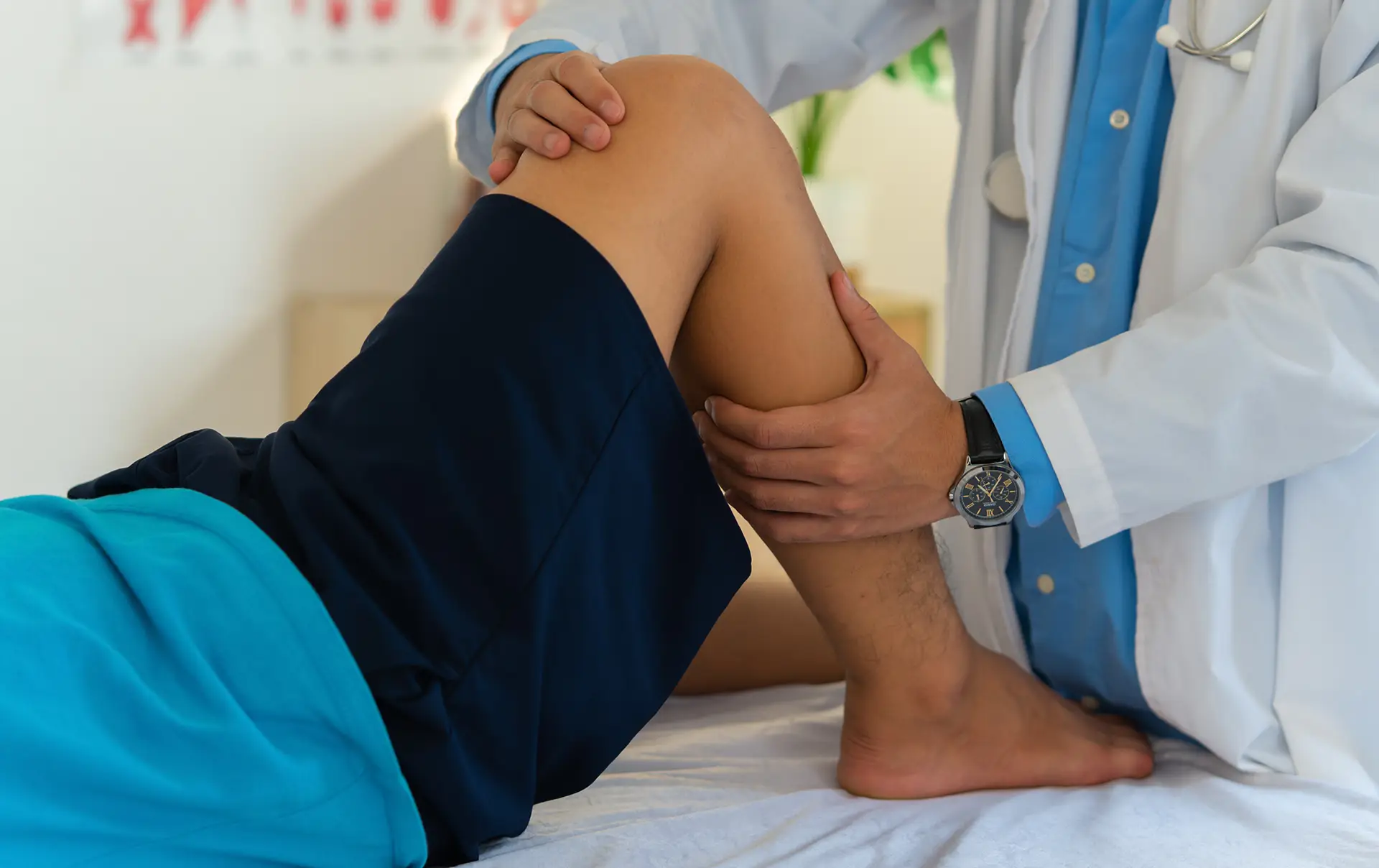 Male doctor in white gown examined the patient with knee pain problem