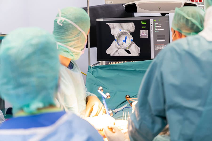 Tech-assisted hip replacement surgery.